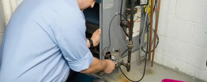 Furnace repair technician inspecting and servicing a home heating system in Columbus, OH