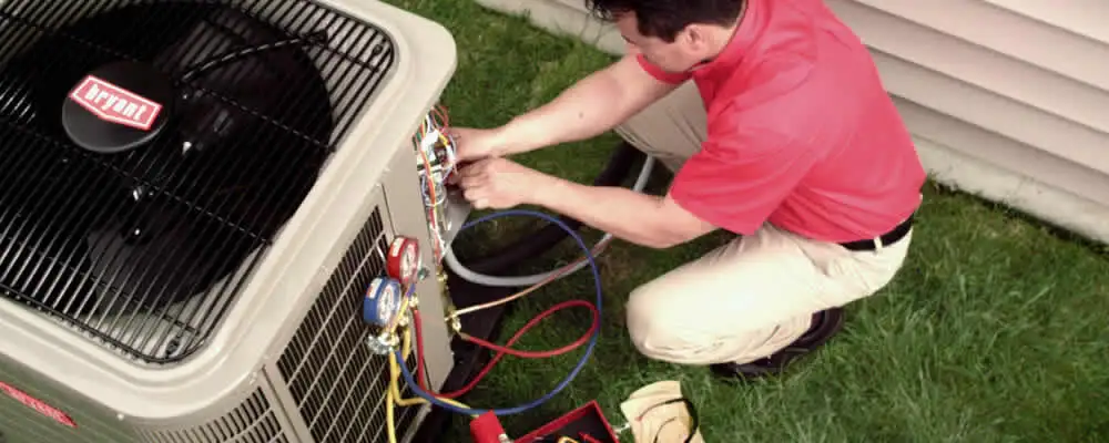 HVAC technician servicing an outdoor air conditioner unit in Columbus, OH
